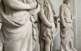 Three stone statues standing in a workshop. The statues are of a Greek Goddess, Robert Burns and William Shakespeare.