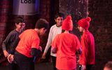 Primary pupils standing in a circle on a stage