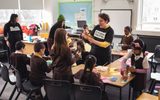 A group of schoolchildren doing a crafting workshop with a Citizens Theatre facilitator.