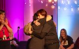 Two women hugging.