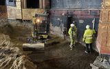 Building work in the Citizens Theatre auditorium. The team checking the depth of the pit as excavation was taking place.
