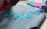 A close-up of a craft project. The word 