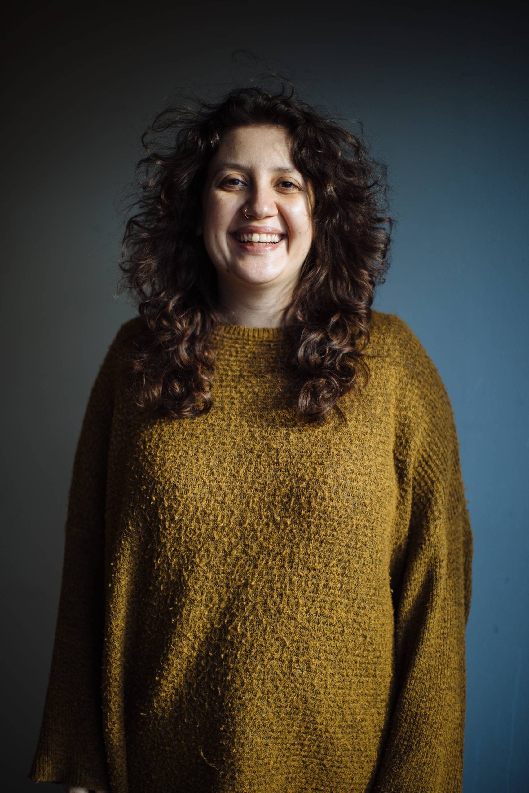Headshot of director Sara Shaarawi smiling at the camera.