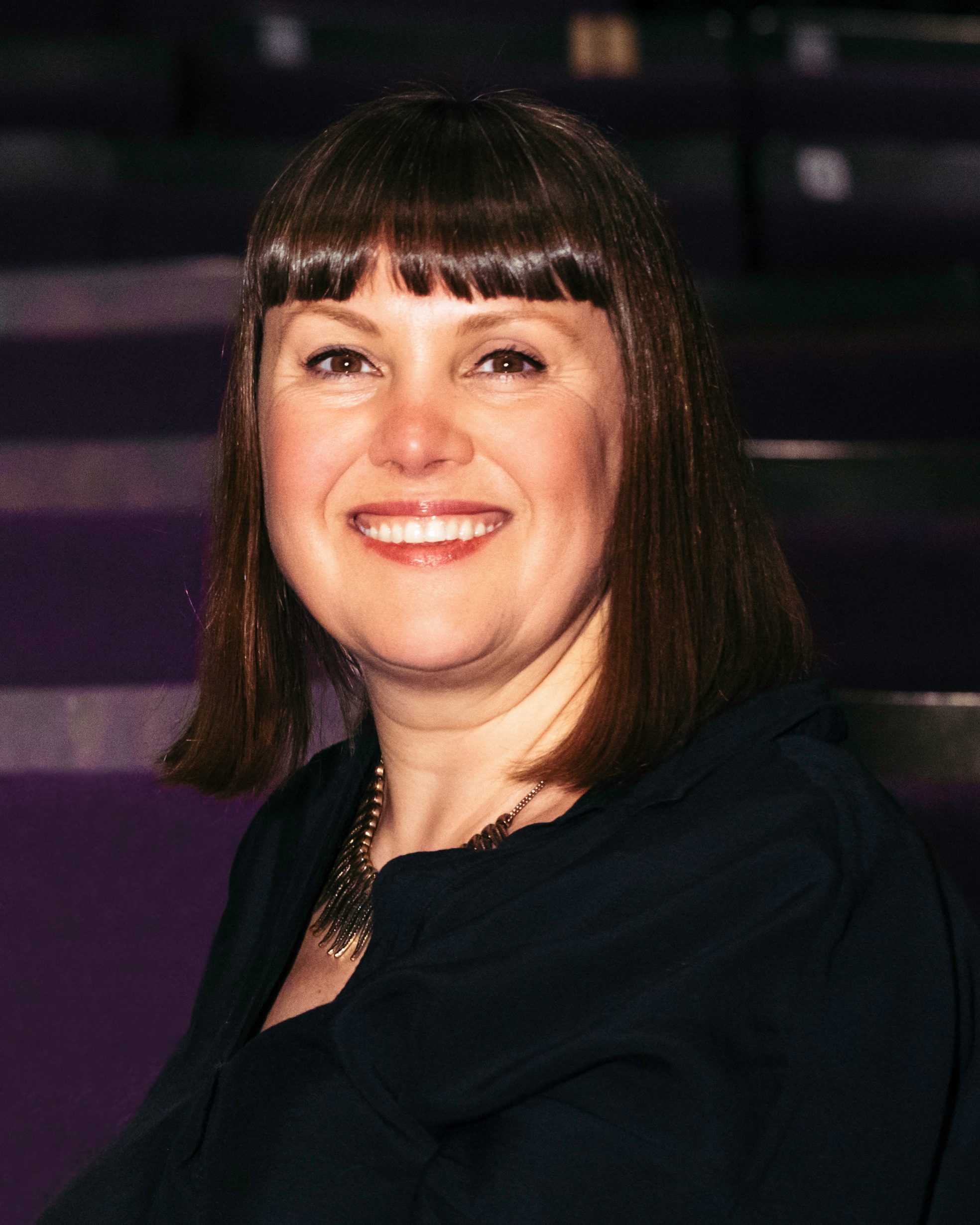 Kate Denby smilling at the camera.