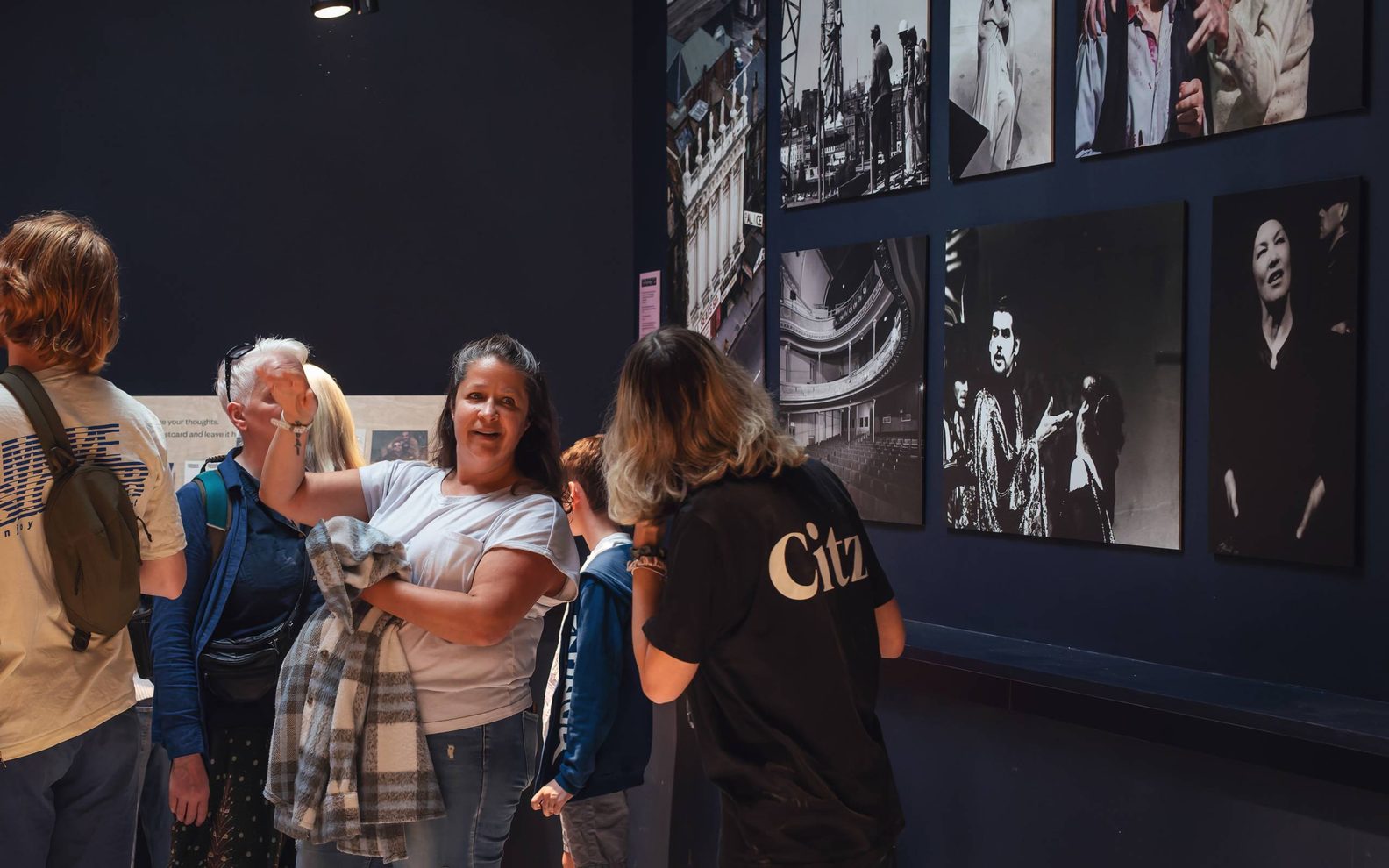 A group of people looking at historic photos of the theatre