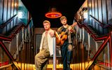 Jamie Rea and Dylan Wood standing together on a staircase