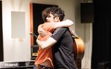 Two men hugging.