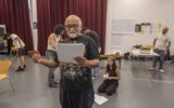 Bhasker Patel in rehearsals from East is East. He is reading from a script in his hand.