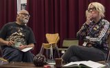 Bhasker Patel and Samantha Power in rehearsals for East is East. They are sitting talking together, Samantha is smoking a cigarette and Bhasker is holding a cup and saucer.