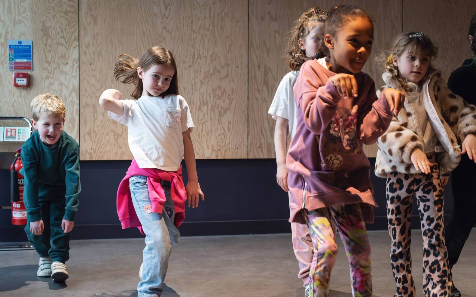 A group of primary school children taking part in a drama class at the Citizens Theatre.