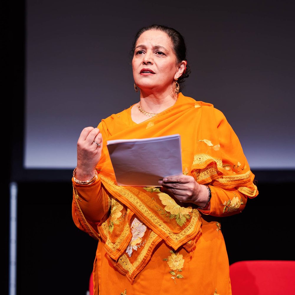 An indian woman reading a script